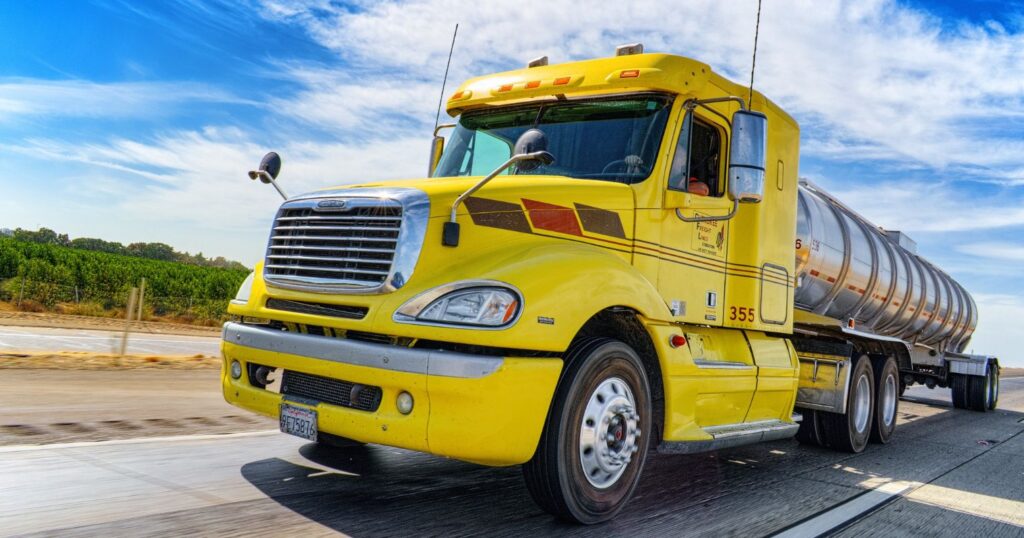 Egy sárga kamion látható a képen